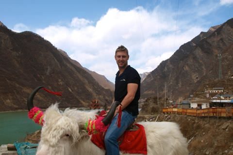 sitting on a yak